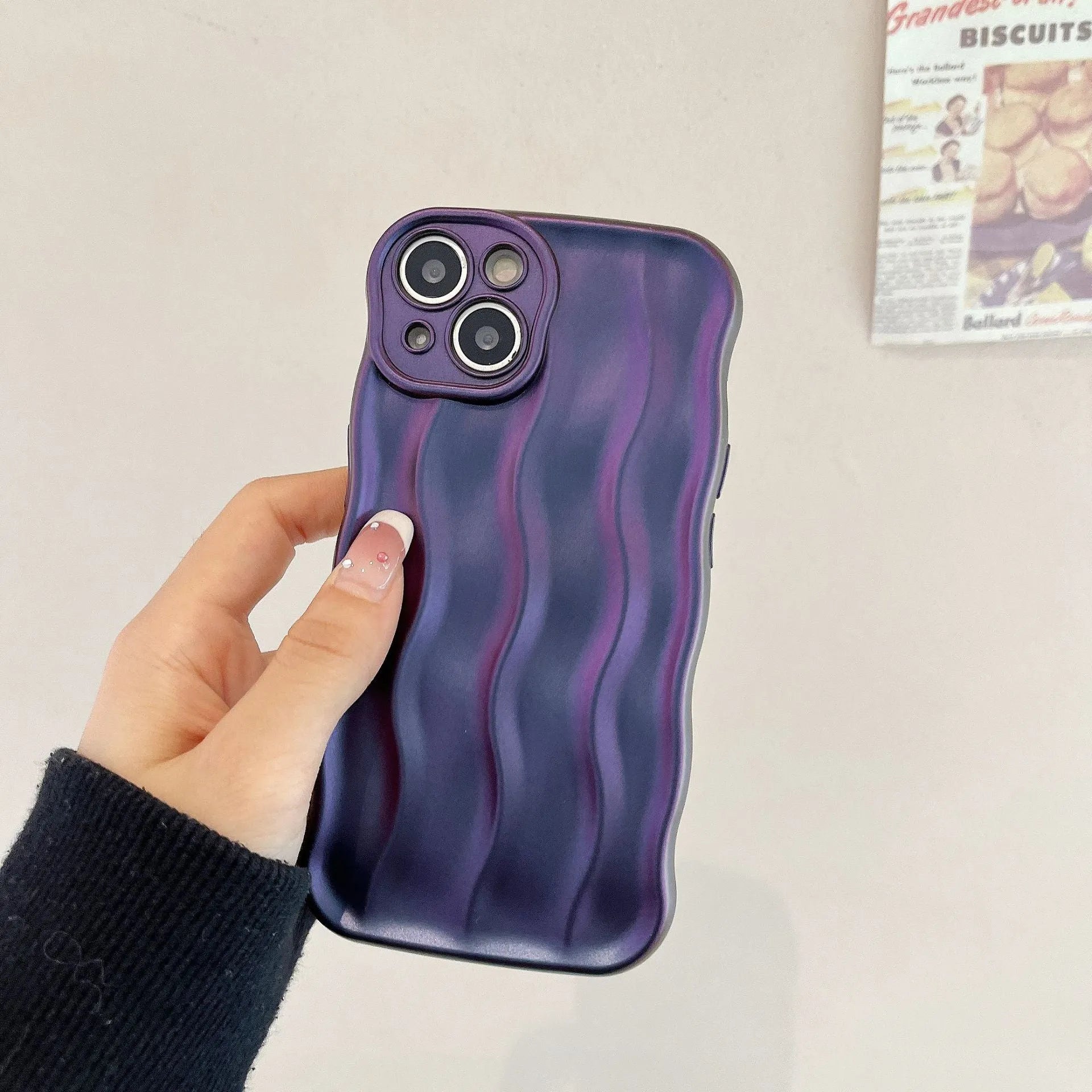 Silicone iPhone case with water ripple texture in green, shown on an iPhone 17 model