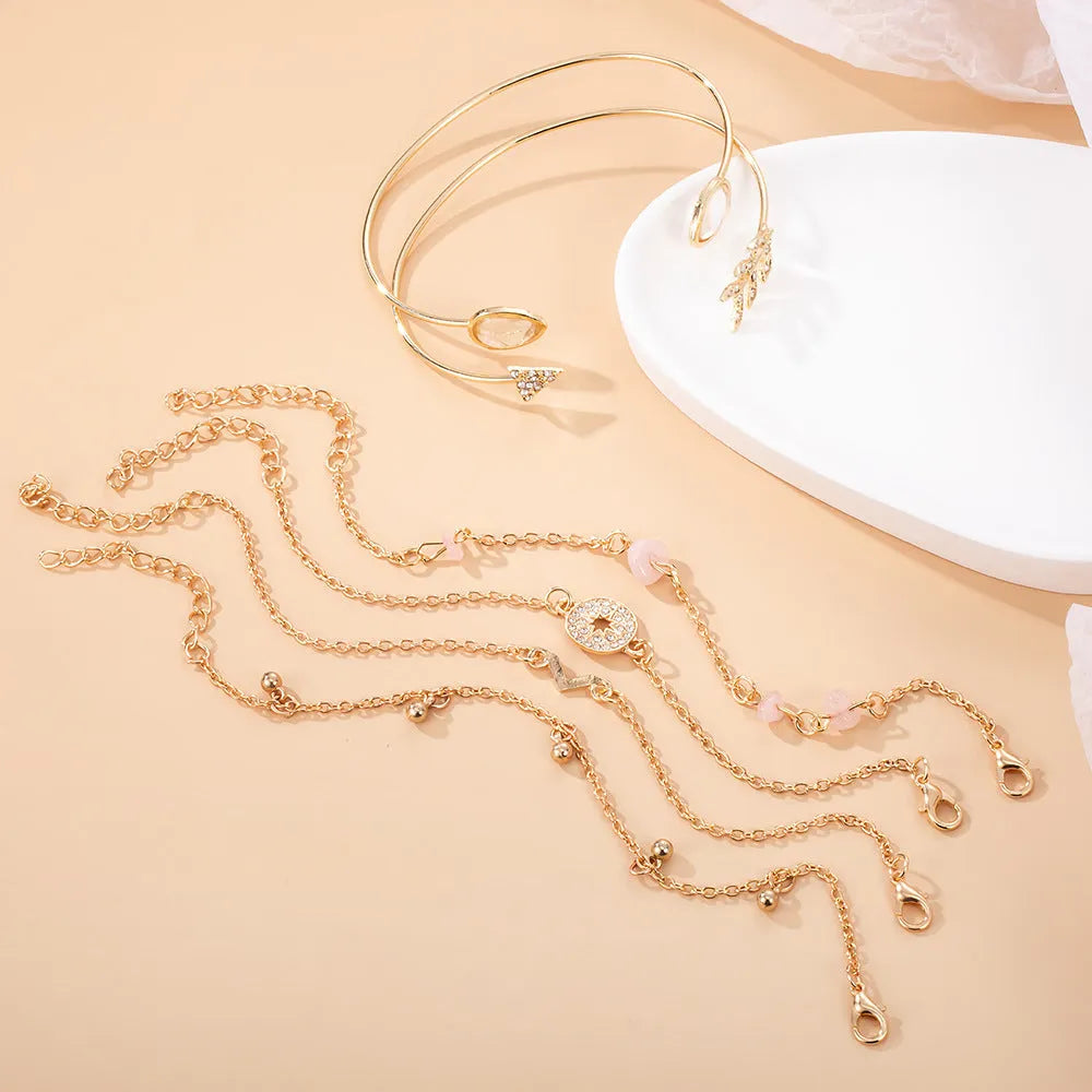 6 piece gold women's bracelet set with water droplet and arrow-shaped charms on zinc alloy construction