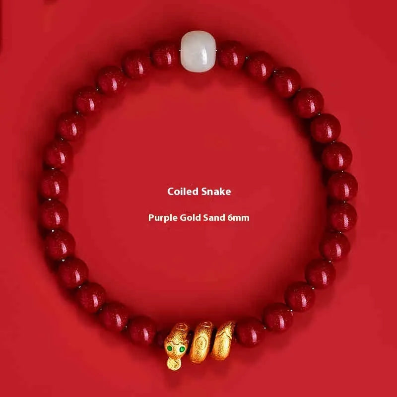Handmade red cinnabar bracelet with snake Zodiac bead on a wrist, showing 8mm bead size.