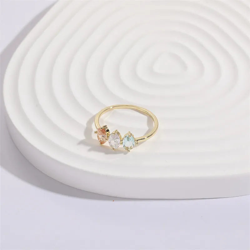 Geometric triangle birthstone ring with horse eye tricolor zircon stones in gold finish
