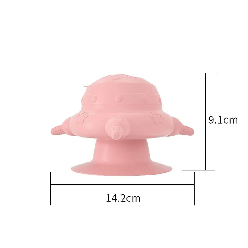 Pink silicone pet nursing milk bowl with four attached pacifiers on a flat base.