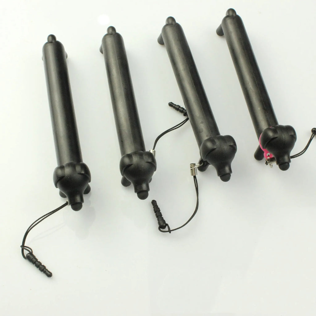 Black dog-shaped touch screen stylus with conductive body shown next to smartphone demonstrating phone holder function