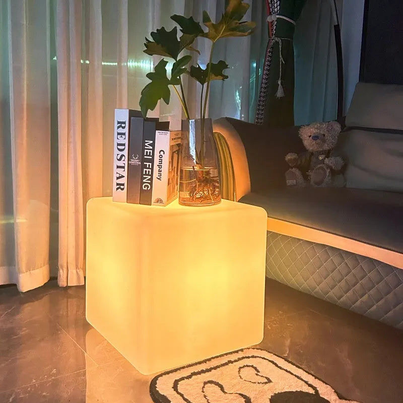 Square LED cube light stool in modern design showing waterproof PE construction with solar panel or charging port visible