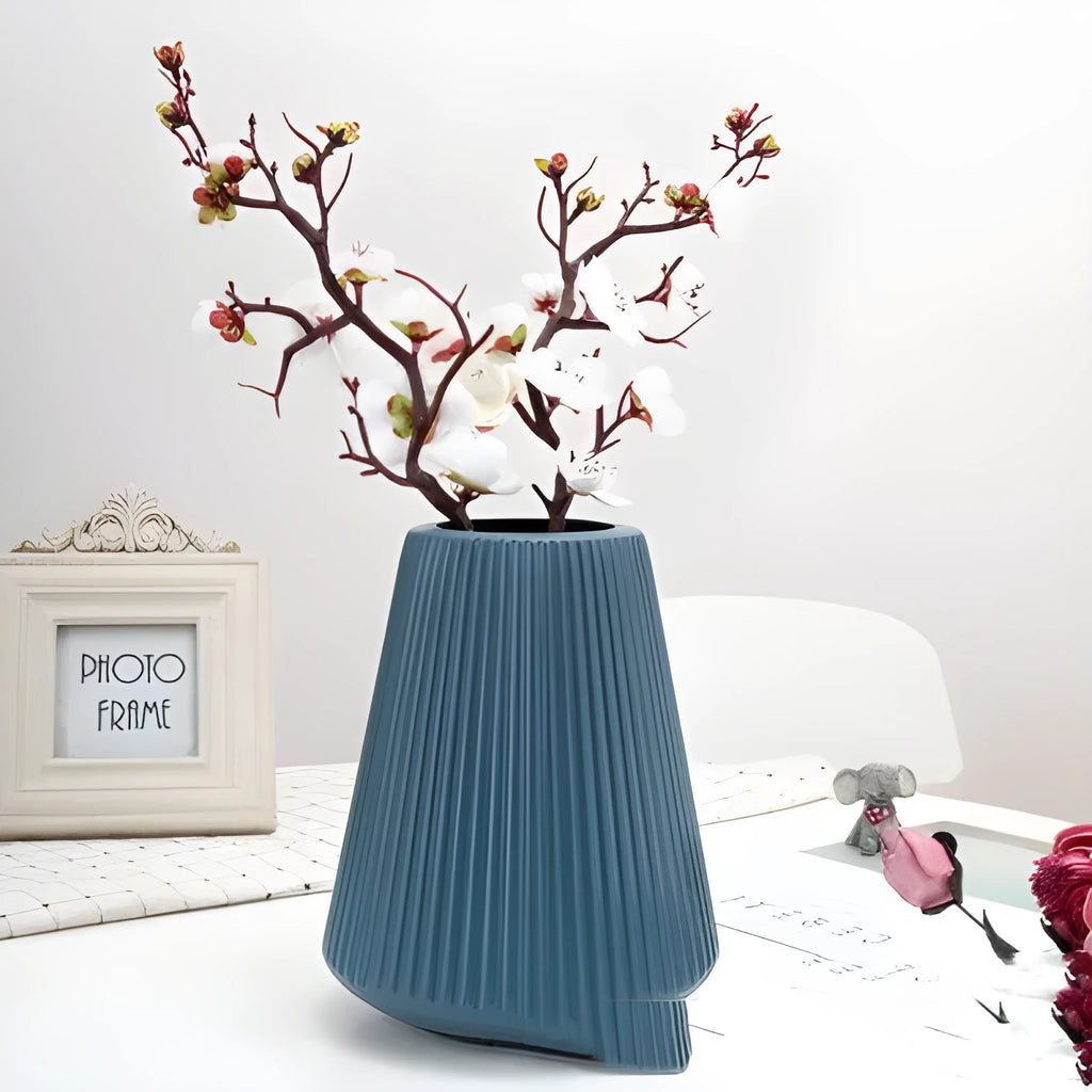Colourful melamine plastic decorative flower vase measuring 16cm by 20cm on a desktop.