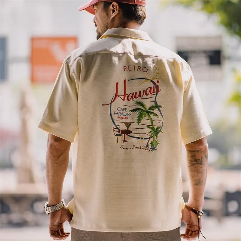 Light apricot men's shirt with a bamboo and floral pattern and a Cuban collar.