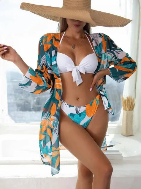 Women's three-piece bikini swimsuit set with mesh detail, including top, bottoms, and a matching coat.