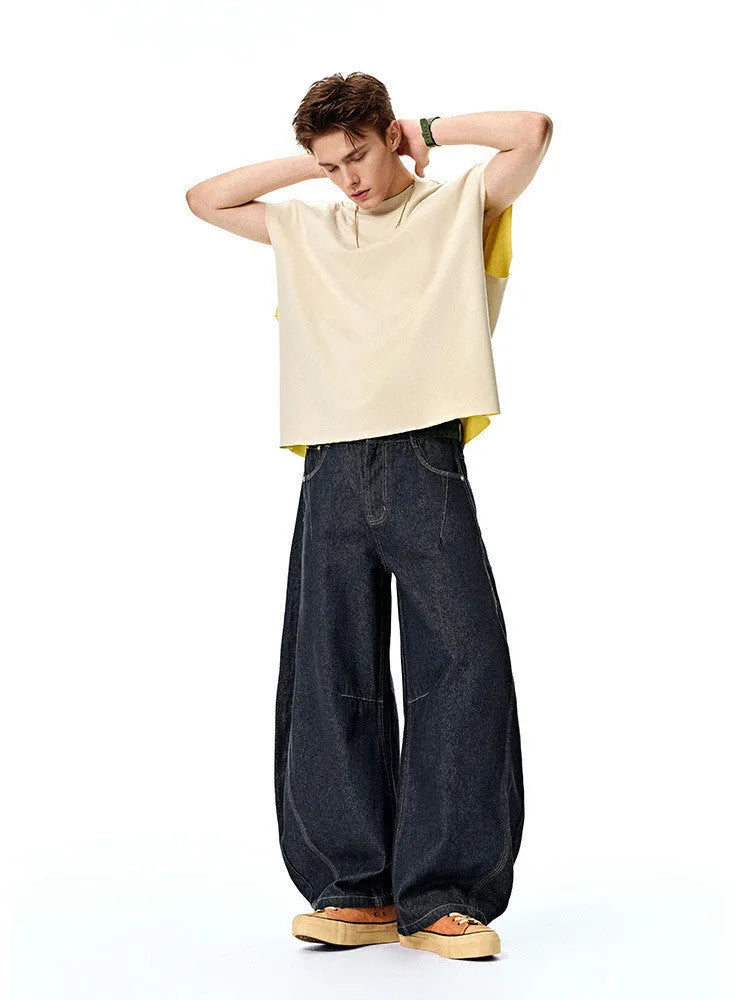 Men's original cow coloured wide leg denim trousers with a mid waist, laid flat.