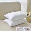 White hotel cotton satin stripe feather and cotton blend pillow showing satin stripe detail.