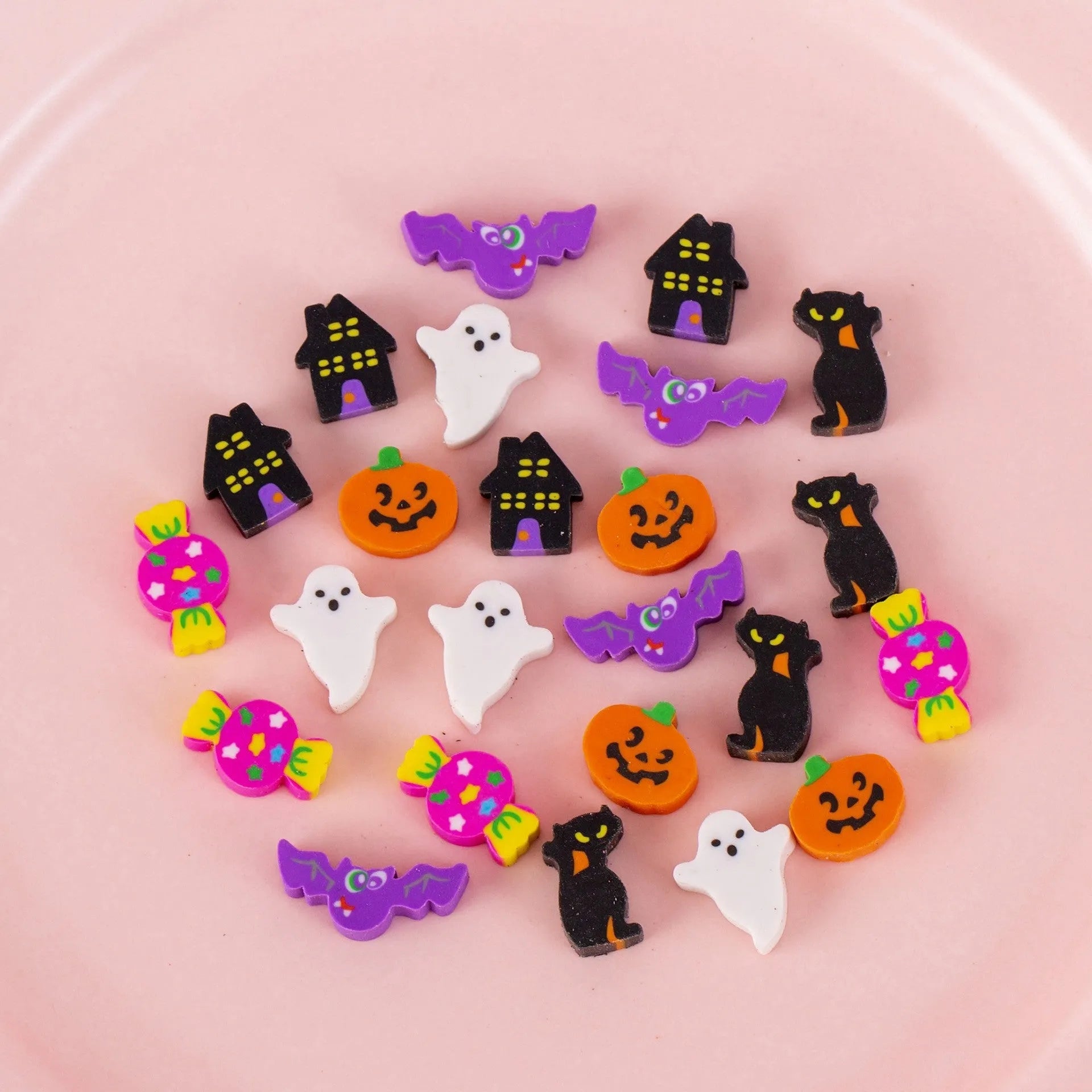 50 small colourful cartoon erasers in a pearlescent bag showing fruit, animal, cake, and Halloween themes.