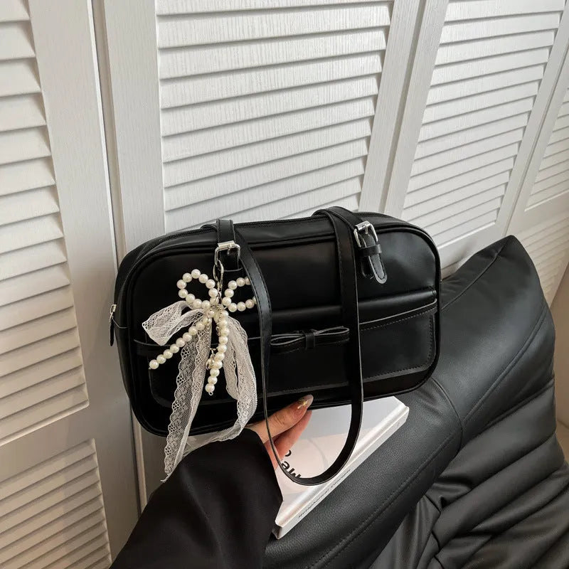 Women's black PU leather single-shoulder flap bag with a phone pocket and double-joint straps.