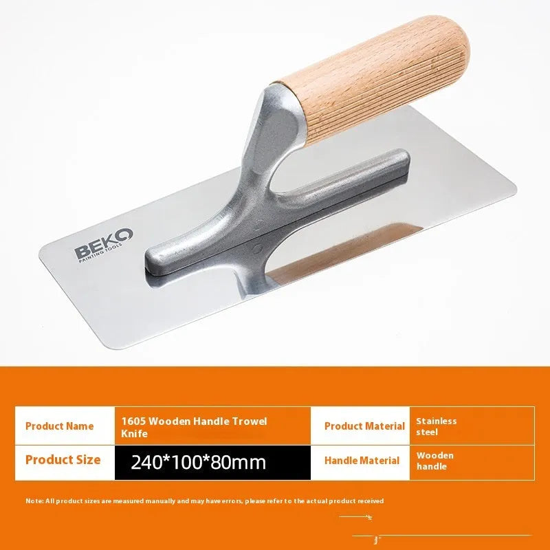 Three stainless steel putty scraper tools with wooden handles in different sizes on a workbench.