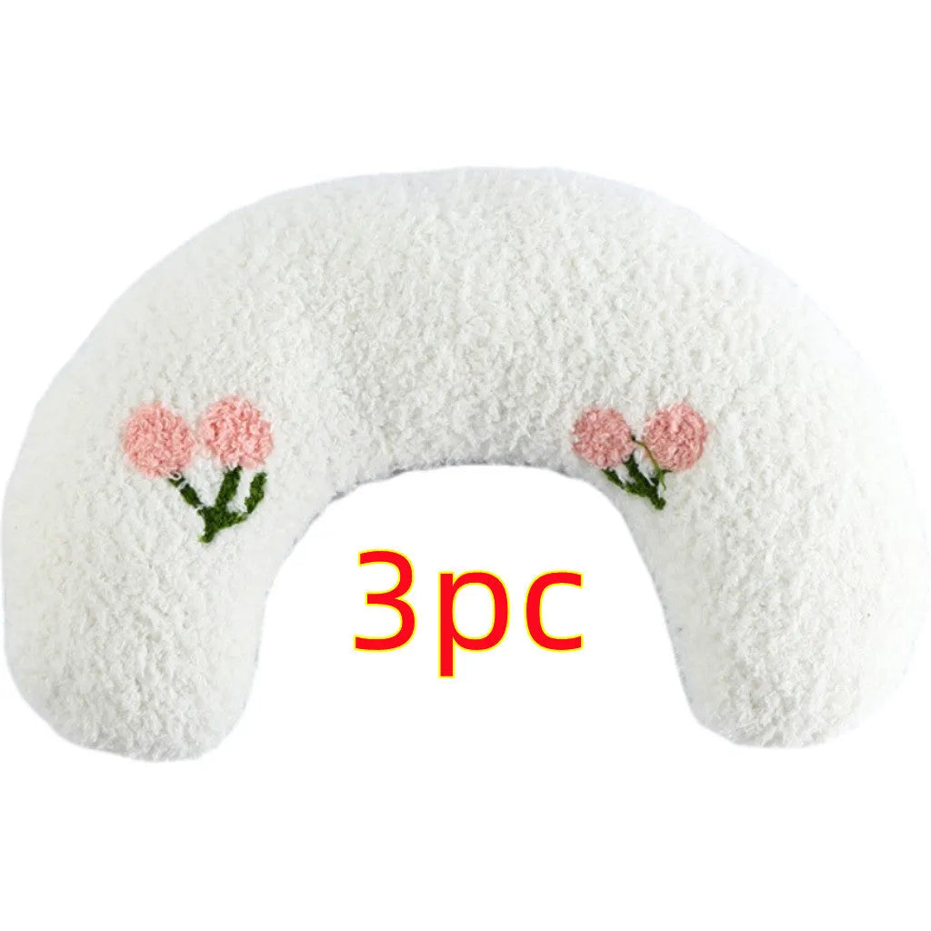 Small blue U-shaped plush pillow for cats or small dogs on a white background.