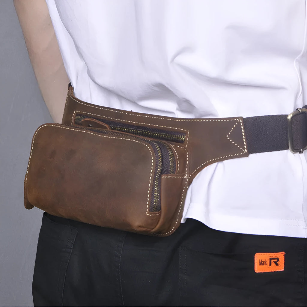 Brown top layer cowhide men's sports waist bag with a pull closure.