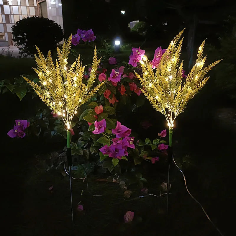 A pink flower-shaped solar LED garden light standing 74 cm tall in an outdoor setting.