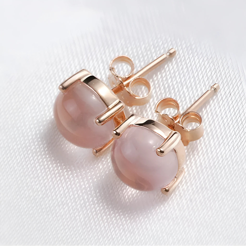 Rose gold coloured drop shape stud earrings with crystal inlay on silver base.