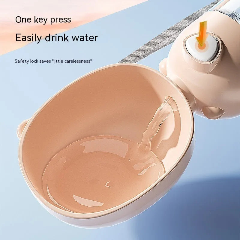 Portable dog water bottle with an attached feeding bowl in yellow, for outdoor travel.
