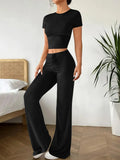 Women's black high waist trousers and short sleeve T-shirt suit set on a hanger