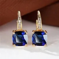 Square geometric ear hook earrings with zircon stones in an electroplated copper setting.