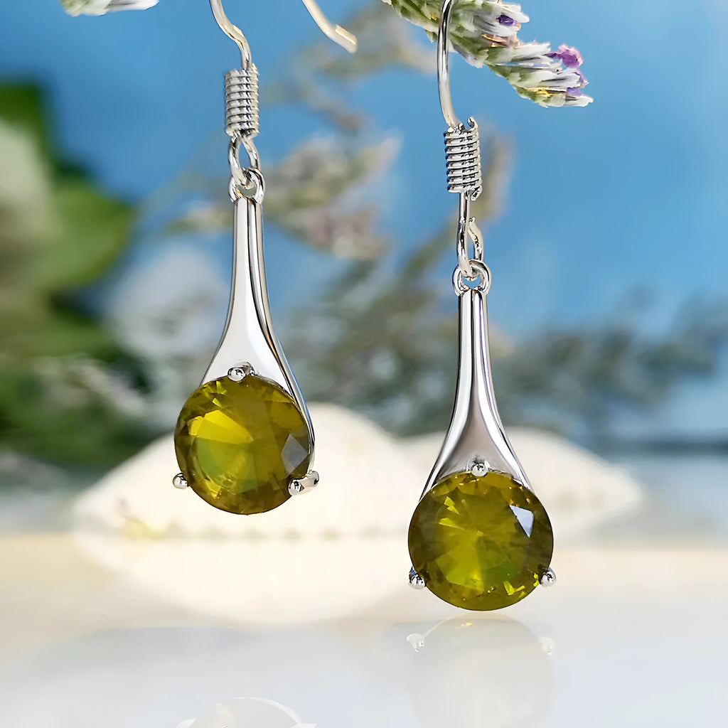 Olive green topaz coloured drop earrings with a water drop shape and minimalist retro design.