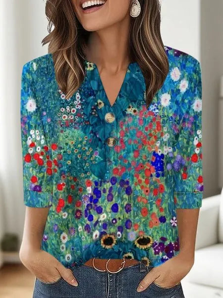 Woman wearing a loose V-neck T-shirt with a bold 3D pattern print in casual style.