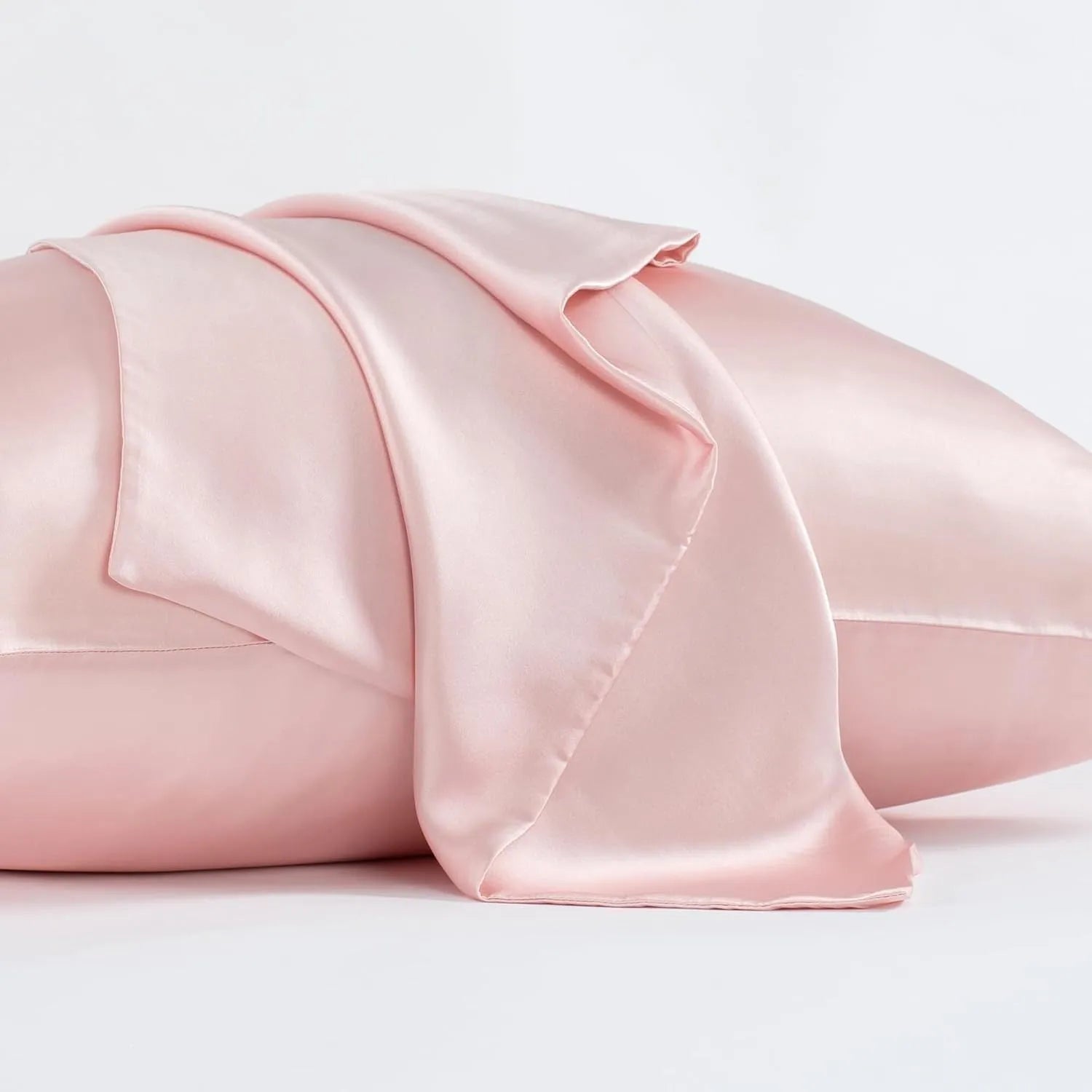 Dark grey mulberry silk pillowcase with an envelope closure on a bed.