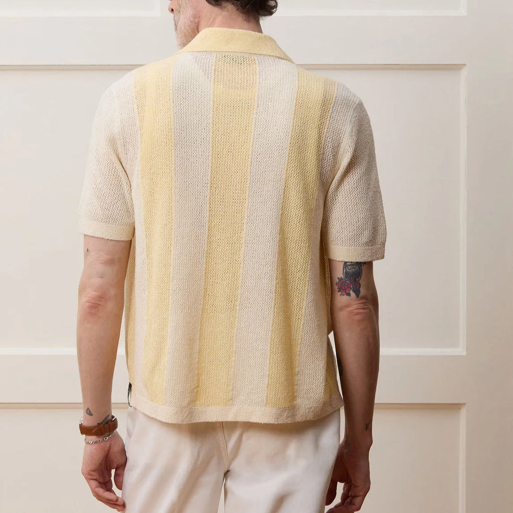 Yellow casual polo shirt with asymmetric hollow-out design and short sleeves.