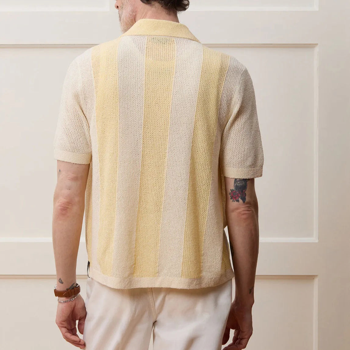 Yellow casual polo shirt with asymmetric hollow-out design and short sleeves.