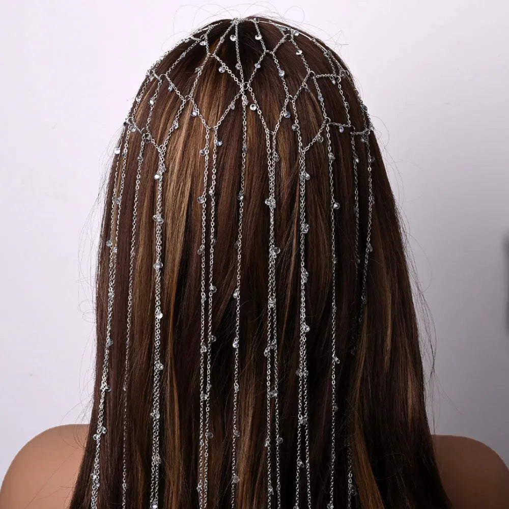 Gold and silver rhinestone mesh headband with a decorative tassel accessory.