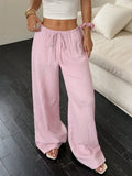Women's black wide leg trousers with lace-up waist detail, shown with pink colour option