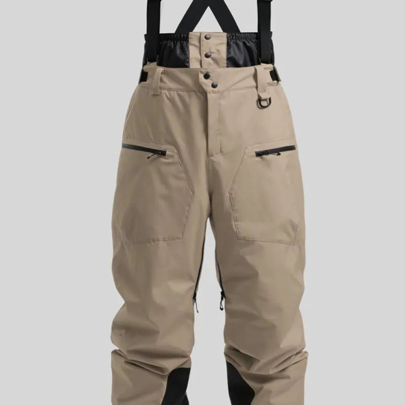 Man wearing black waterproof ski trousers with an adjustable strap on a snowy slope.