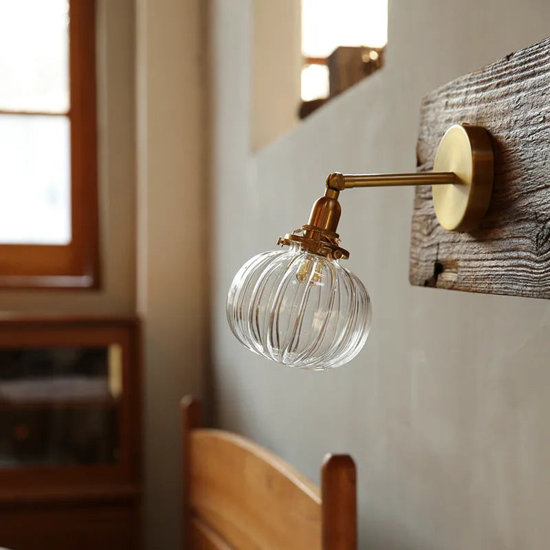 Pumpkin-shaped glass wall lamp in a choice of blue, clear, or water ripple transparent finish.