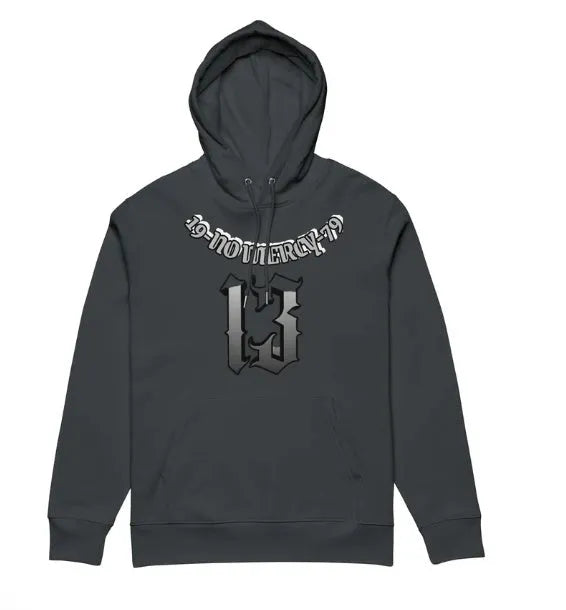 A beige fleece-lined hooded sweater on a hanger, showing its loose pullover fit and front pouch pocket.