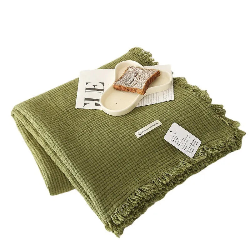 Four-layer gauze cotton blanket with tassel detailing in avocado green colour