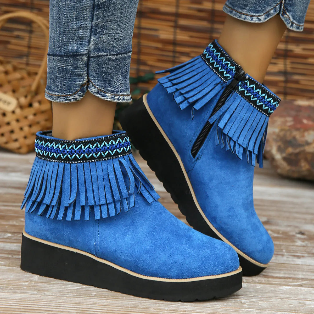 Women's black suede wedge ankle boots with side zip, tassel, and thick rubber sole.