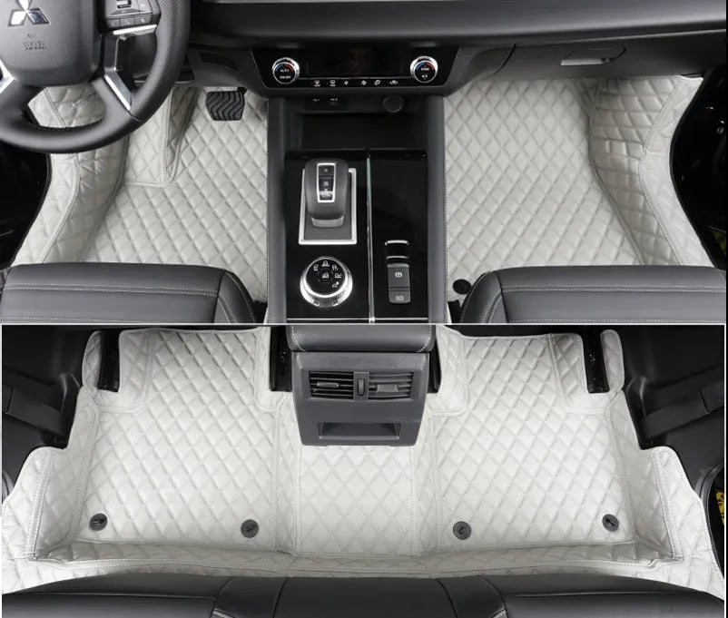 Custom black PU floor mats fitted in a Mitsubishi Outlander footwell.