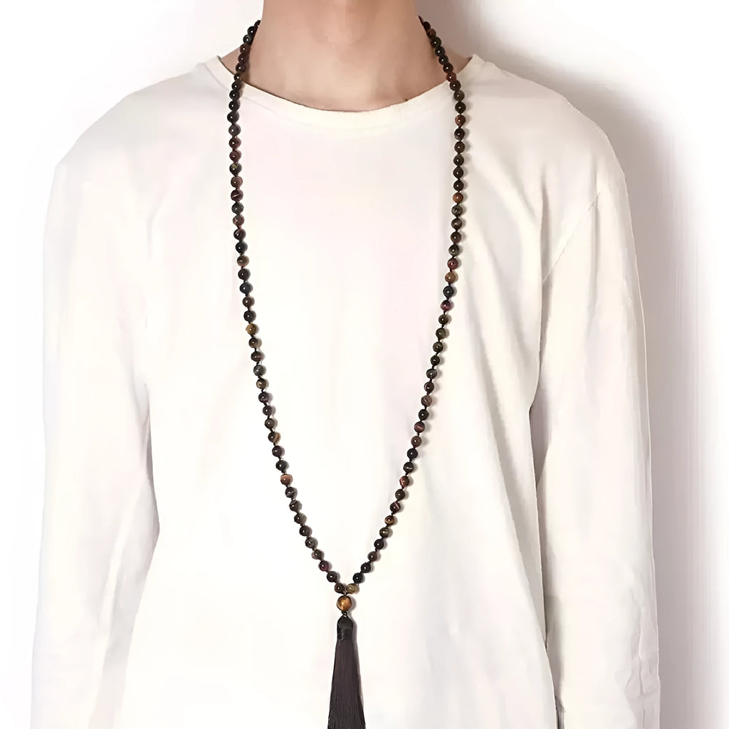 Long agate tassel necklace with geometric stone beads in various colours on a neutral background.