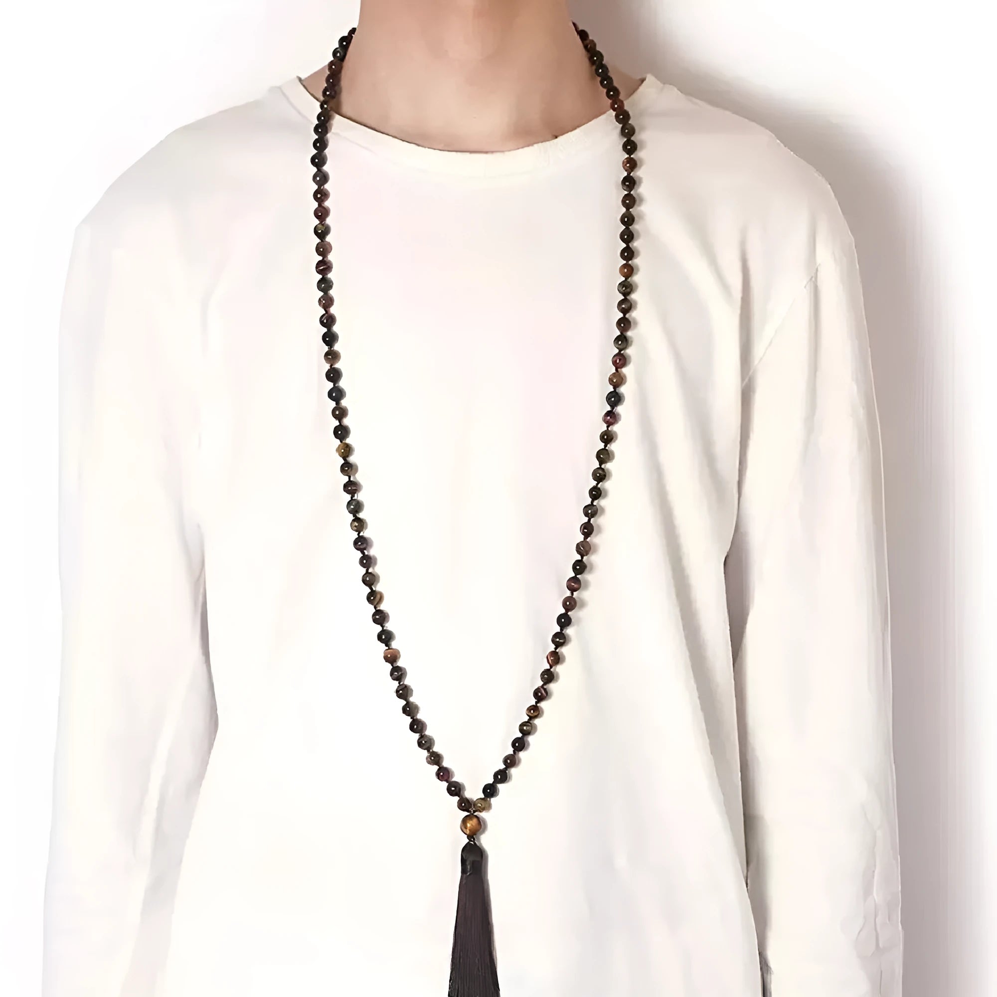 Long agate tassel necklace with geometric stone beads in various colours on a neutral background.