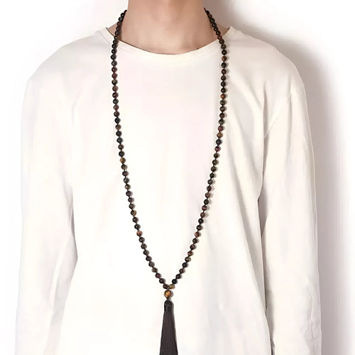 Long agate tassel necklace with geometric stone beads in various colours on a neutral background.