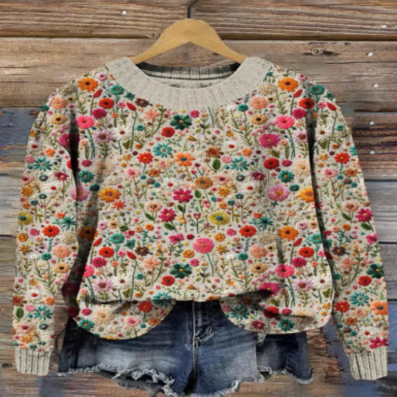 Women's lilac floral printed round neck sweater on a hanger showing the knitted texture.