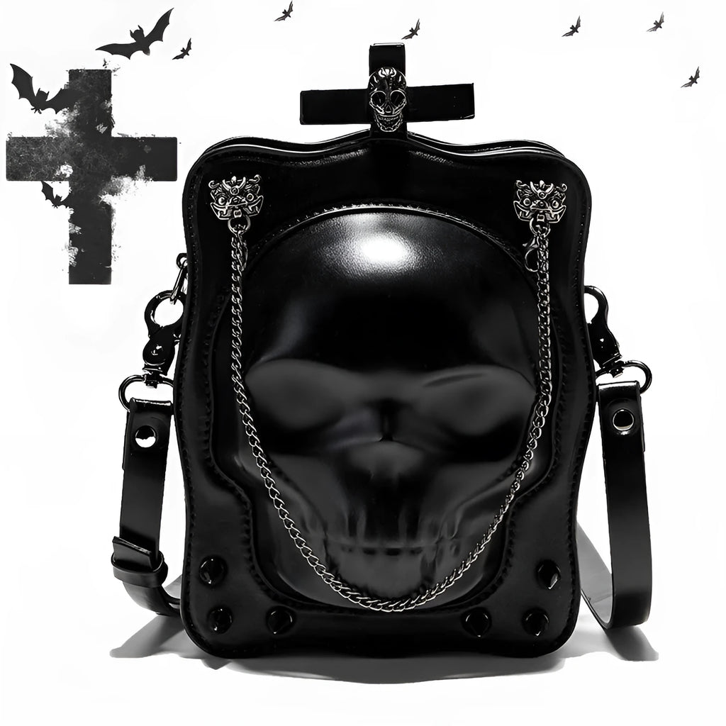 Black mini square crossbody bag with embossed skull design, decorative stitching, rivets, and chain details.