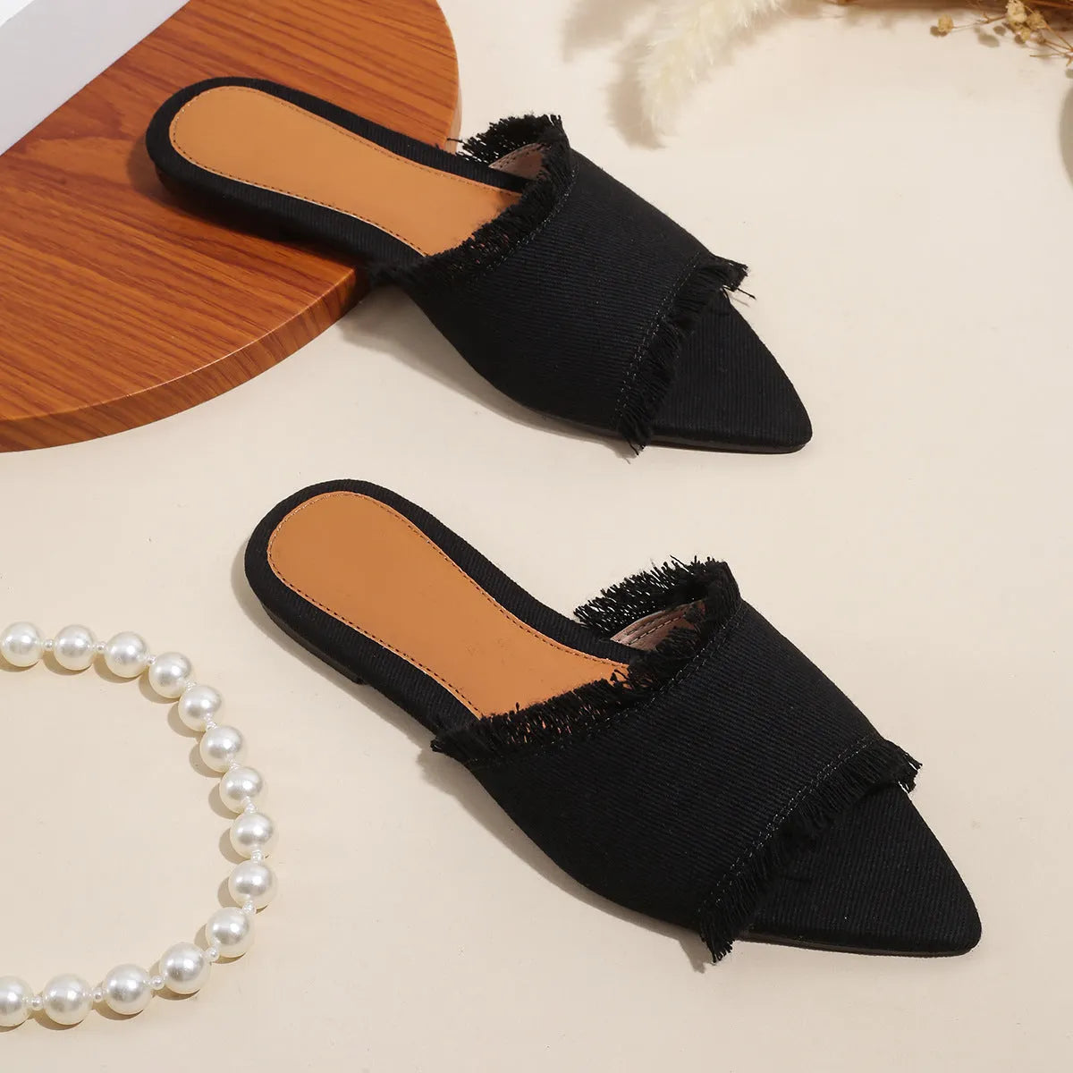 Women's flat denim slippers with tassel detail in apricot colour on a white background