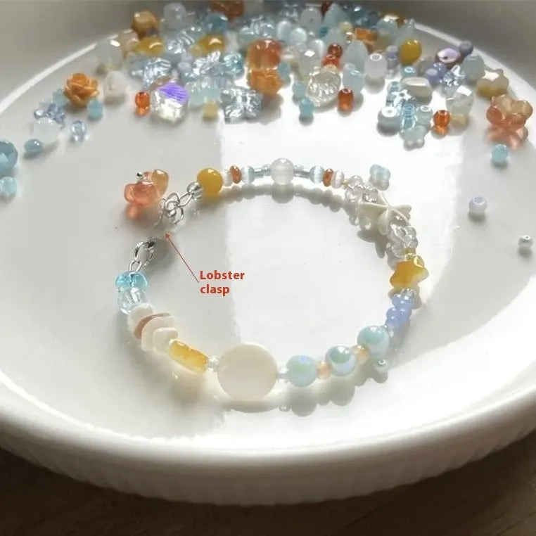 Orange sea coloured mixed material summer bracelet with diamond shape and round elements