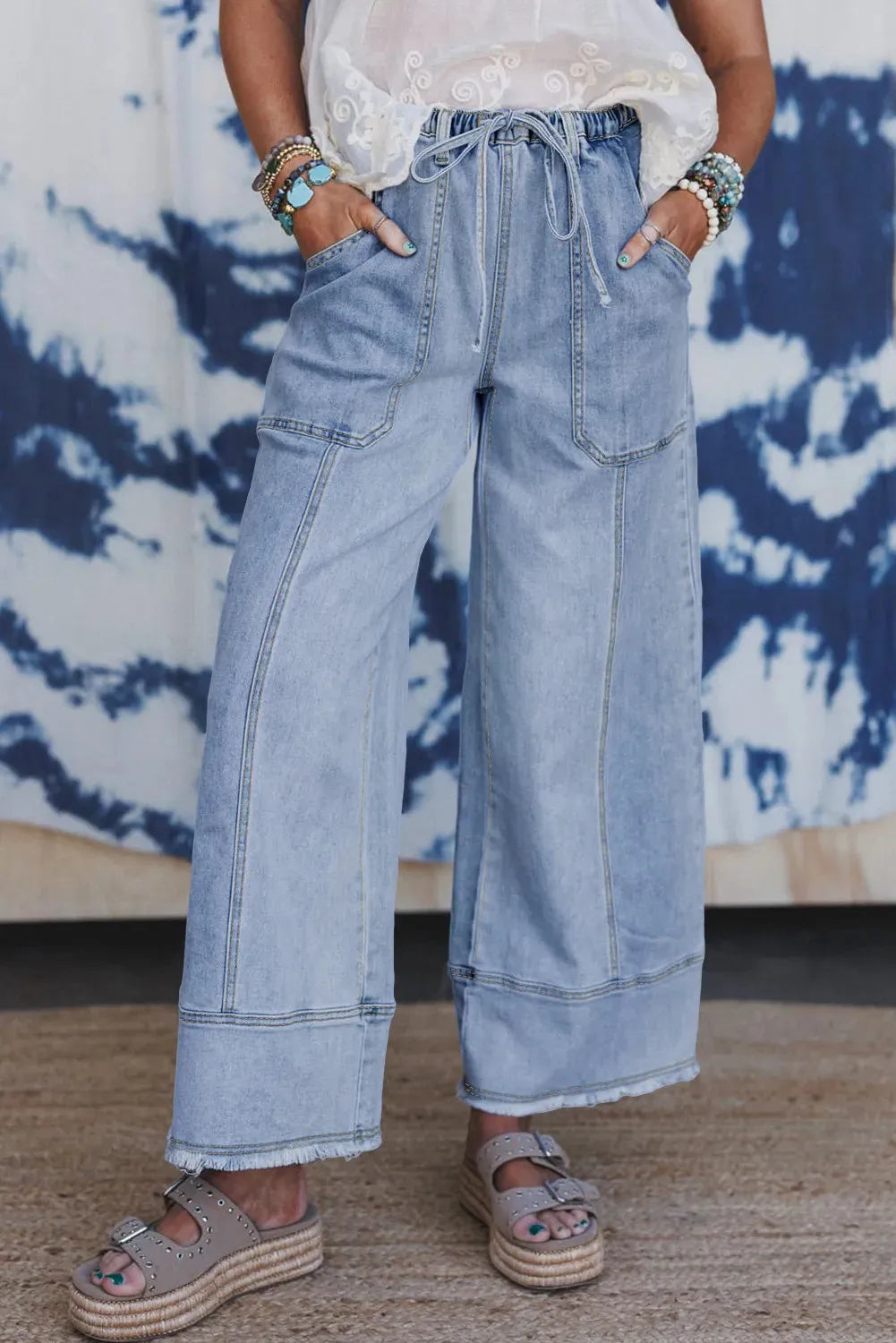 Beau Blue women's wide leg denim trousers with drawstring waist and raw hem.