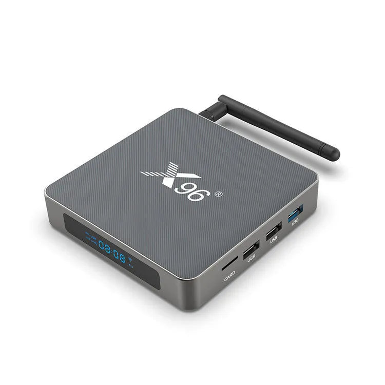 Android smart TV set-top box with voice remote control, HDMI cable, and power adapter on a table.