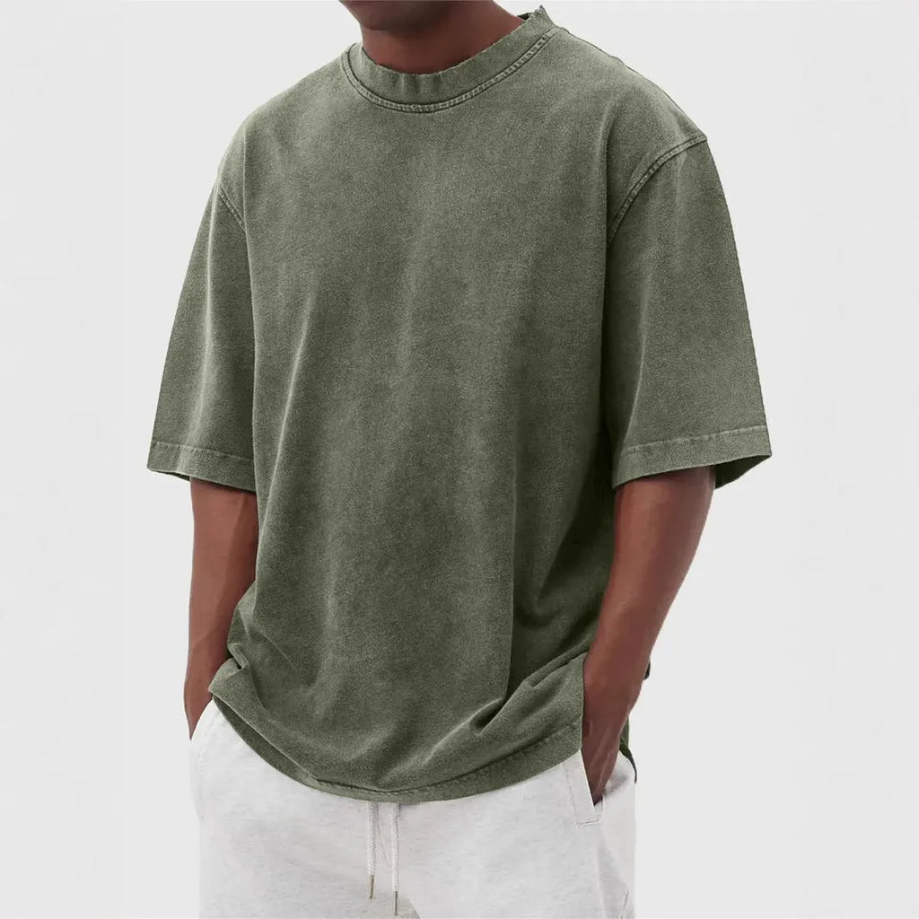 Men's loose-fit stone-washed t-shirt in army green showing distressed texture and pullover style.