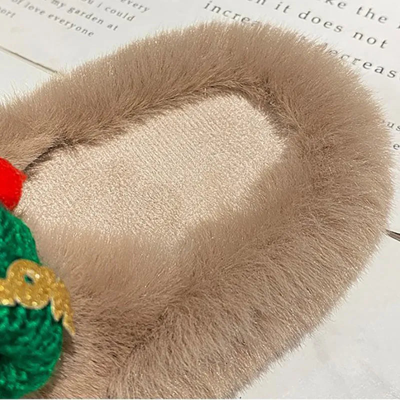 Women's black Christmas slippers with Santa hat decoration on plush faux fur upper.