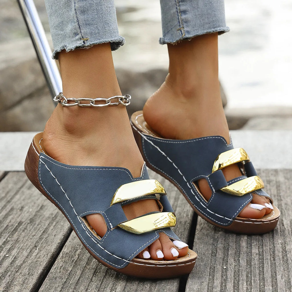 Roman-style platform flip-flops in a solid colour with a metal detail and rubber sole.