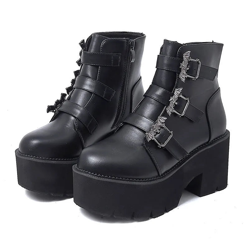 Black women's punk style ankle boots with bat buckle and side zip.