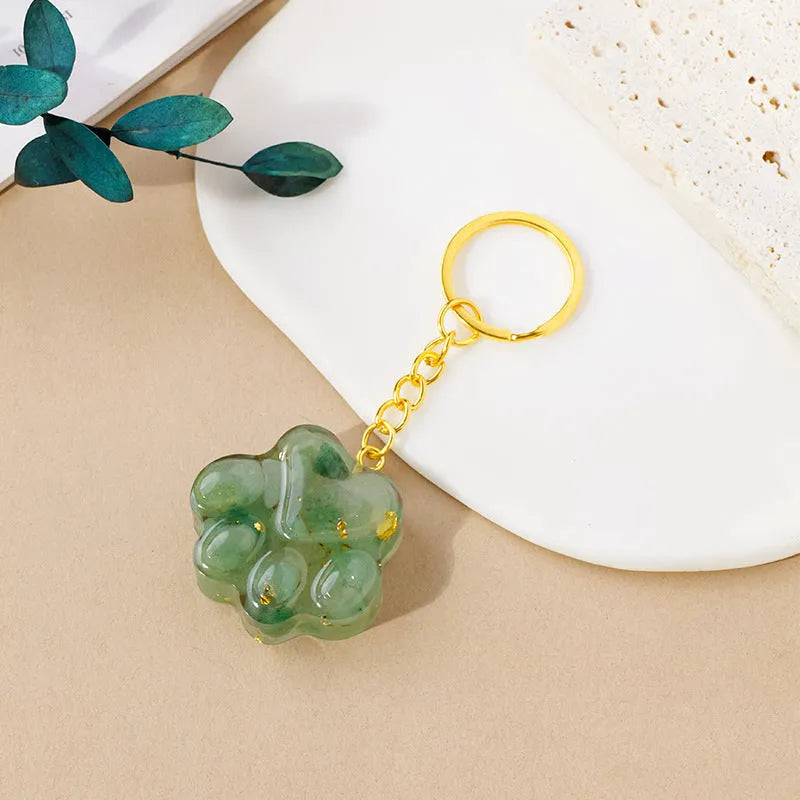 Natural crystal cat's paw keychain pendant in various gemstone colours including pink, red, blue, and green