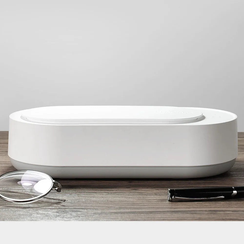 White portable ultrasonic cleaner machine with stainless steel tank for cleaning jewellery and glasses.